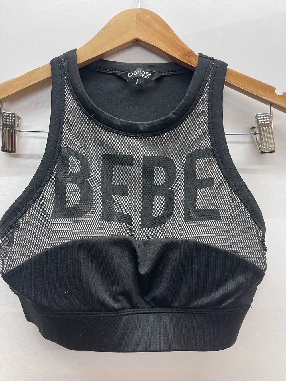 Bebe Sport logo sports bra featuring mesh netting details and a racerback design